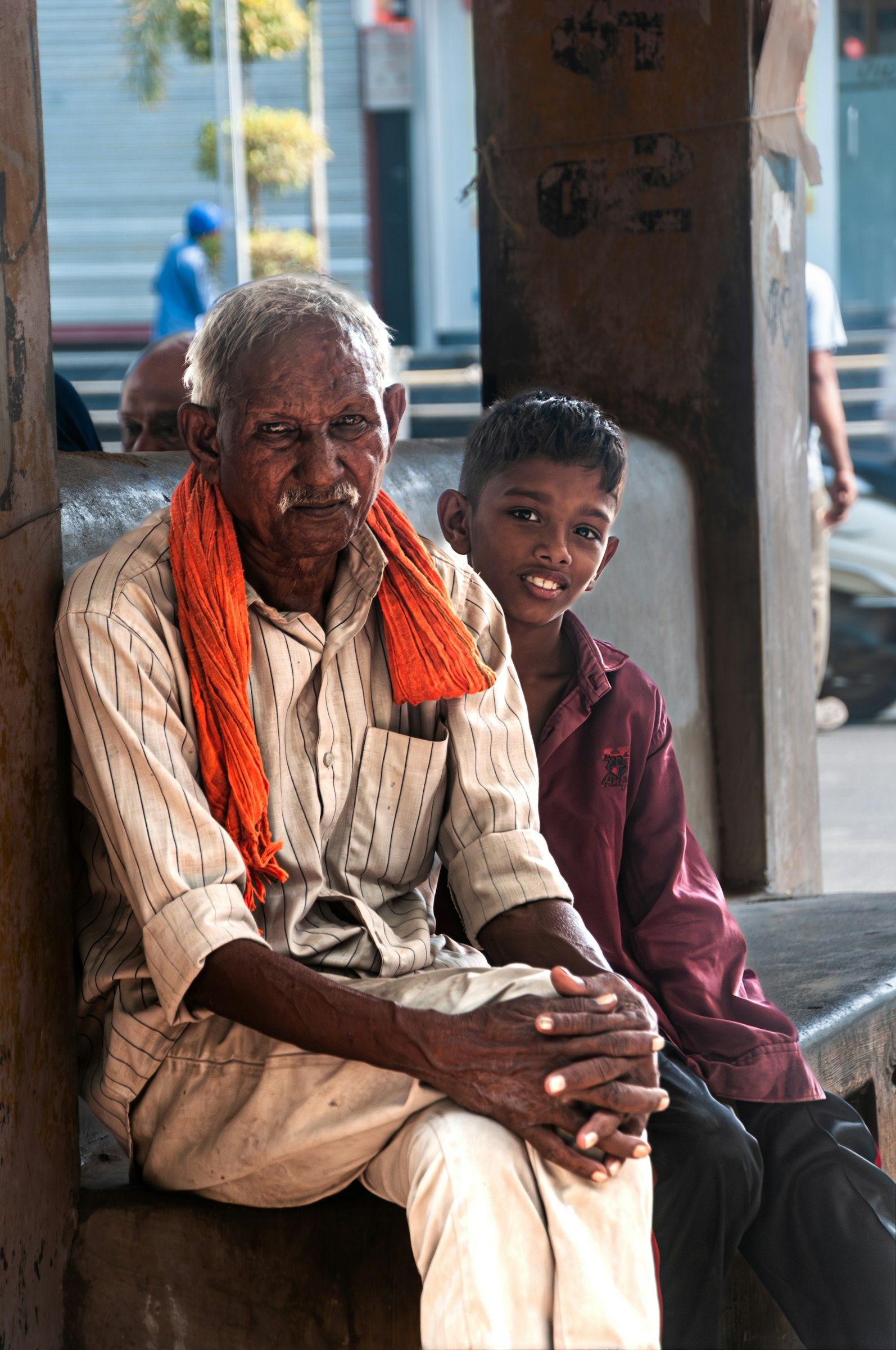 A grandfather and grandson smiling together